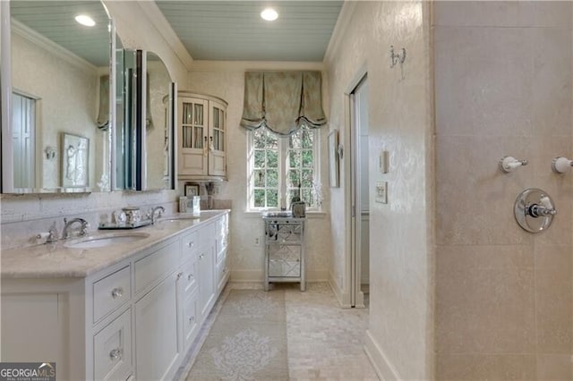 bathroom featuring tile patterned flooring, ornamental molding, and vanity