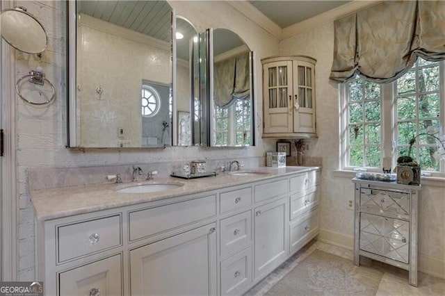 bathroom with ornamental molding and vanity