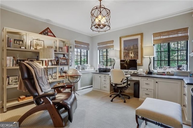 home office featuring light carpet, built in desk, plenty of natural light, and ornamental molding