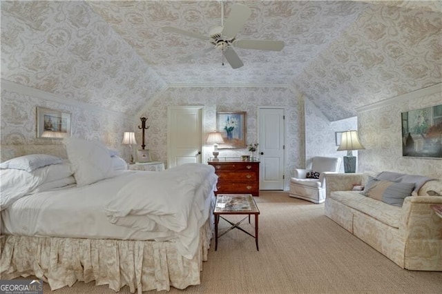 carpeted bedroom with ceiling fan and vaulted ceiling