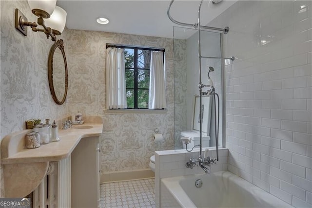 full bathroom with vanity, tiled shower / bath, tile patterned floors, and toilet