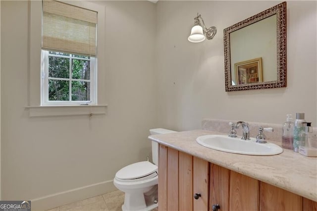 bathroom featuring vanity, tile patterned flooring, and toilet