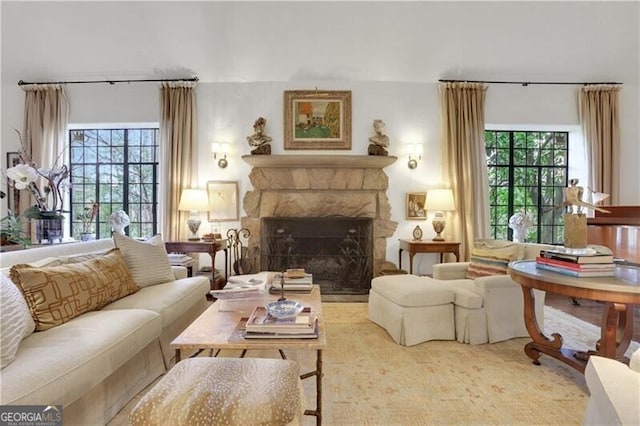 living room with a stone fireplace