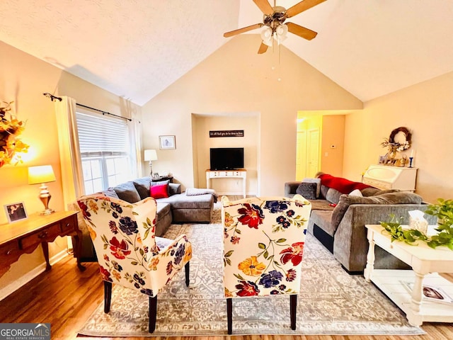 living room with lofted ceiling, hardwood / wood-style floors, and ceiling fan