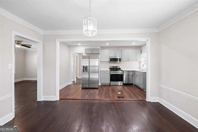 kitchen featuring appliances with stainless steel finishes, dark hardwood / wood-style floors, pendant lighting, sink, and gray cabinetry