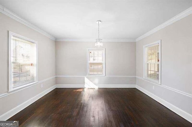 unfurnished room with crown molding, a wealth of natural light, and dark hardwood / wood-style flooring