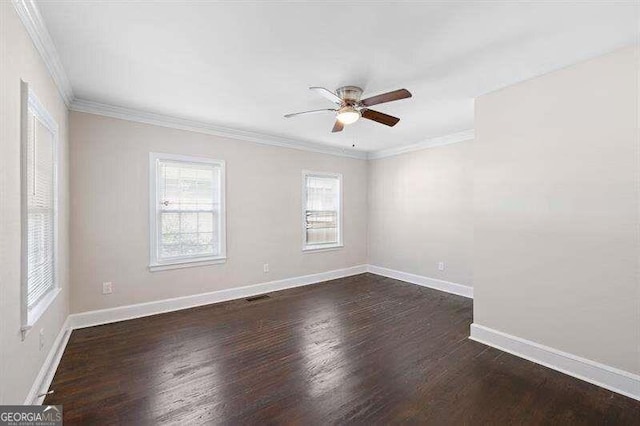 empty room featuring dark wood-type flooring, ornamental molding, and ceiling fan