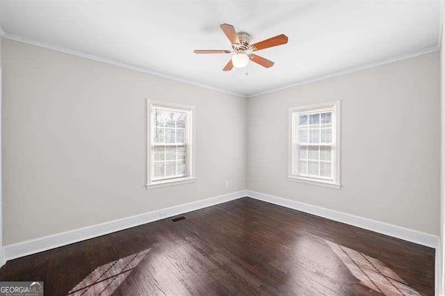 spare room featuring dark hardwood / wood-style flooring, crown molding, and ceiling fan