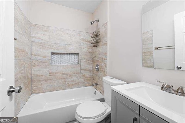 full bathroom featuring vanity, toilet, and tiled shower / bath combo