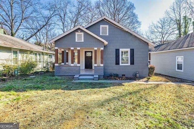 view of front of home with a porch and a front yard