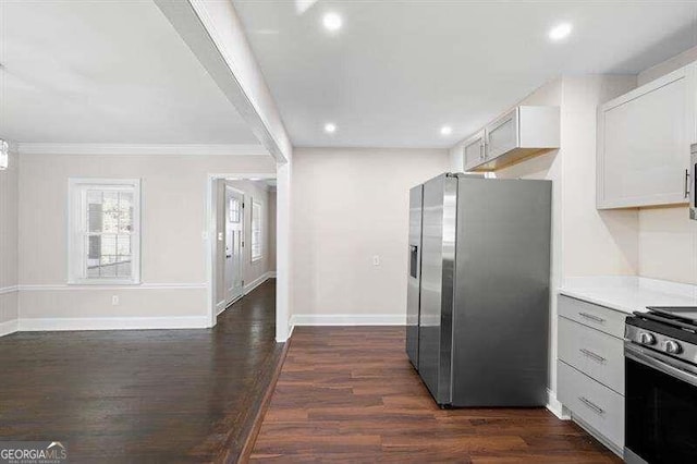 kitchen featuring white cabinetry, crown molding, dark hardwood / wood-style flooring, and stainless steel appliances