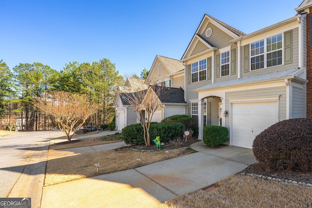 view of front of home with a garage and concrete driveway