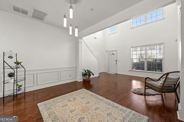 interior space featuring dark wood finished floors, visible vents, and a healthy amount of sunlight