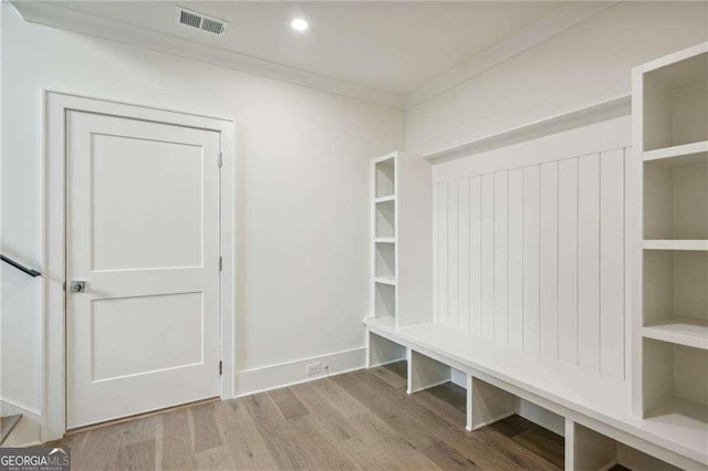 mudroom featuring hardwood / wood-style floors and crown molding