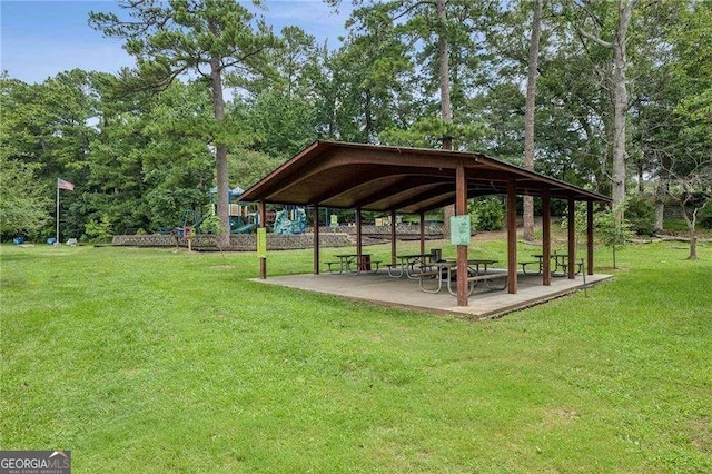 view of community featuring a gazebo, a patio area, and a lawn