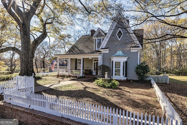 view of front facade with a porch and fence