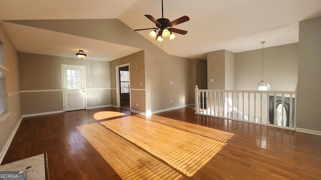 unfurnished room featuring dark hardwood / wood-style flooring, vaulted ceiling, and ceiling fan