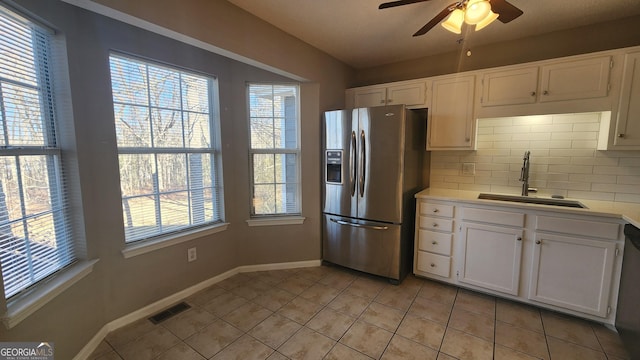 kitchen featuring white cabinetry, stainless steel appliances, sink, and light tile patterned floors