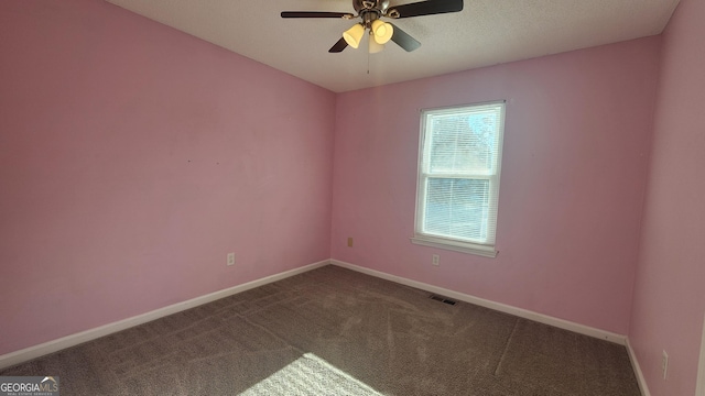 carpeted empty room featuring a textured ceiling and ceiling fan