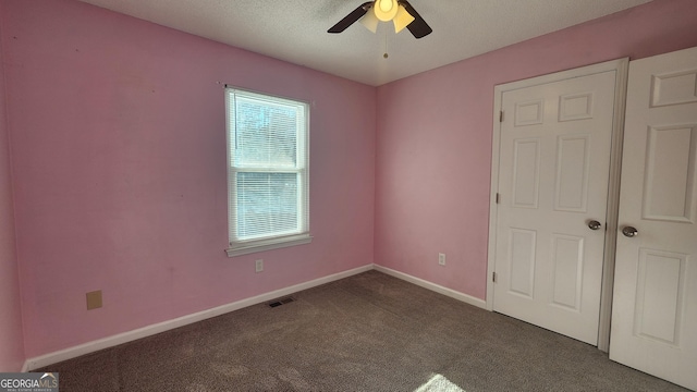 unfurnished bedroom with ceiling fan, a textured ceiling, and carpet flooring