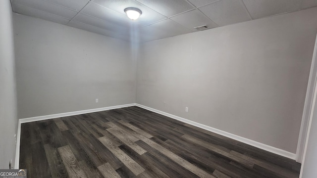 empty room with dark hardwood / wood-style flooring