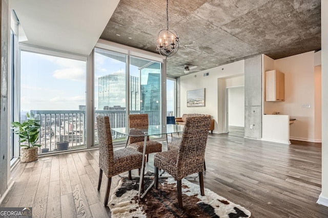 dining space featuring a wall of windows, hardwood / wood-style floors, and a wealth of natural light