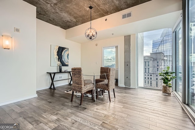 dining area featuring an inviting chandelier and hardwood / wood-style flooring