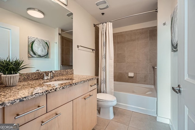 full bathroom with shower / tub combo with curtain, tile patterned floors, toilet, and vanity