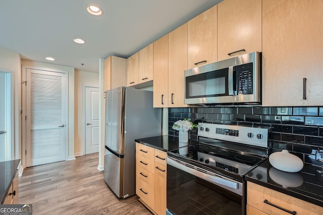 kitchen with stainless steel appliances, light brown cabinetry, and backsplash