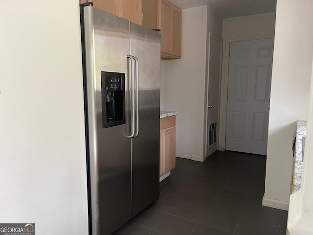 kitchen with stainless steel refrigerator with ice dispenser and light brown cabinetry