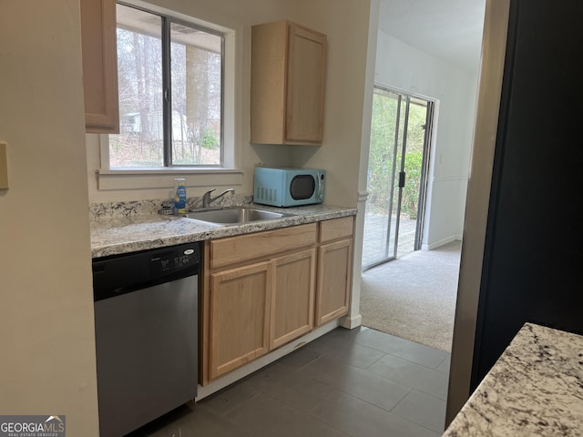 kitchen featuring dishwasher, sink, carpet floors, and light brown cabinets