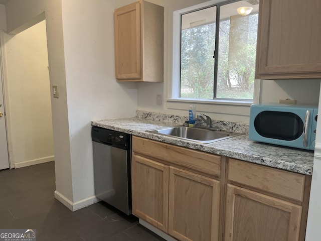 kitchen with stainless steel dishwasher, light brown cabinetry, and sink