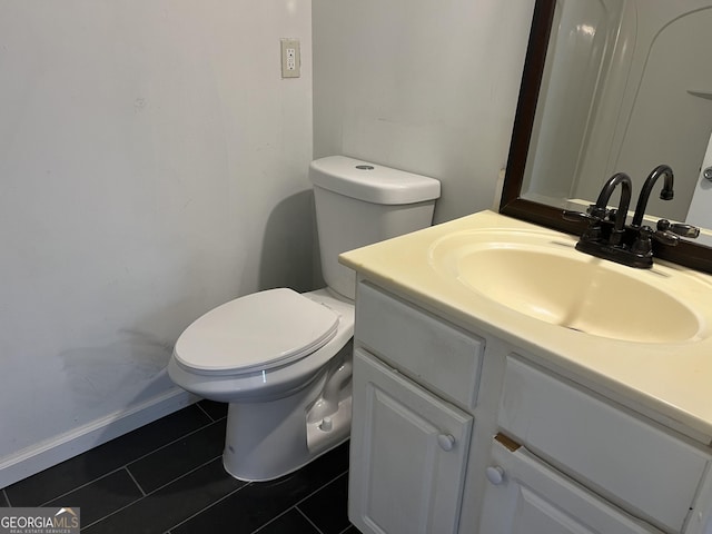 bathroom with vanity, tile patterned flooring, and toilet