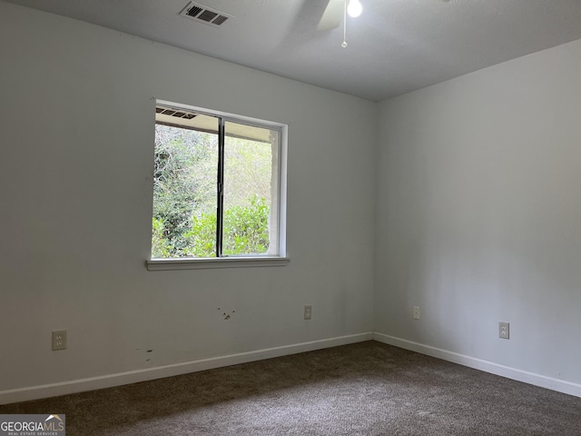 carpeted spare room featuring ceiling fan