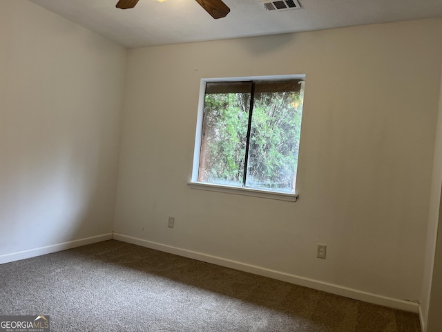 carpeted spare room featuring ceiling fan