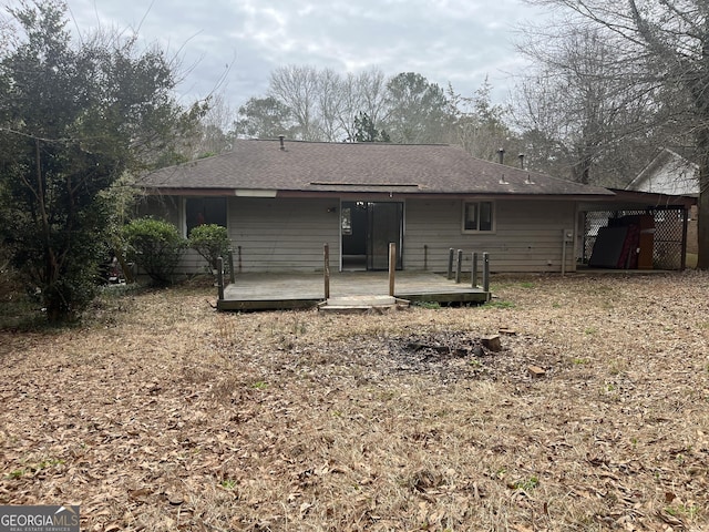 rear view of property featuring a wooden deck