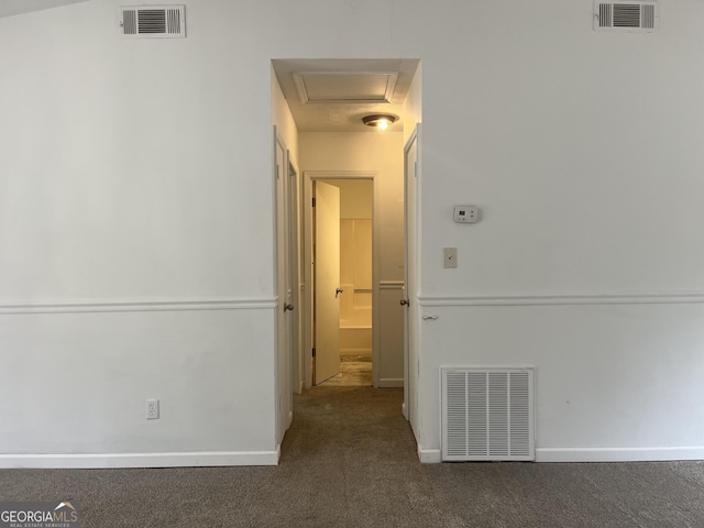 hallway with dark carpet