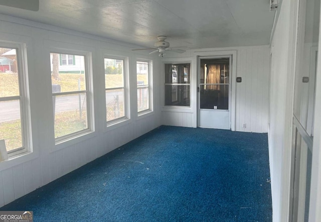 unfurnished sunroom with ceiling fan