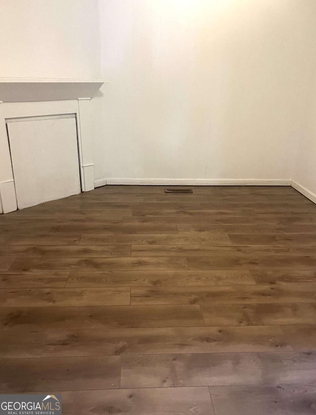 empty room with dark hardwood / wood-style floors