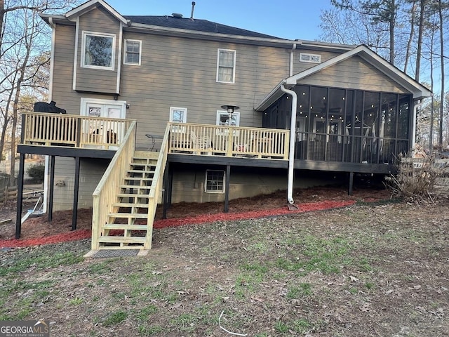 back of property featuring a sunroom and a deck