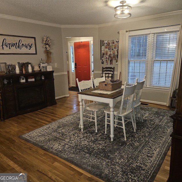 dining area featuring ornamental molding, dark hardwood / wood-style flooring, and a textured ceiling