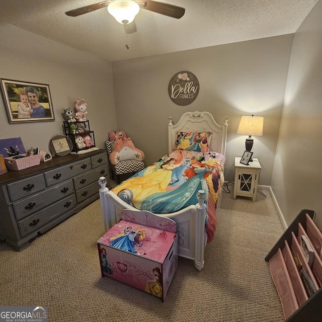 carpeted bedroom featuring ceiling fan and a textured ceiling