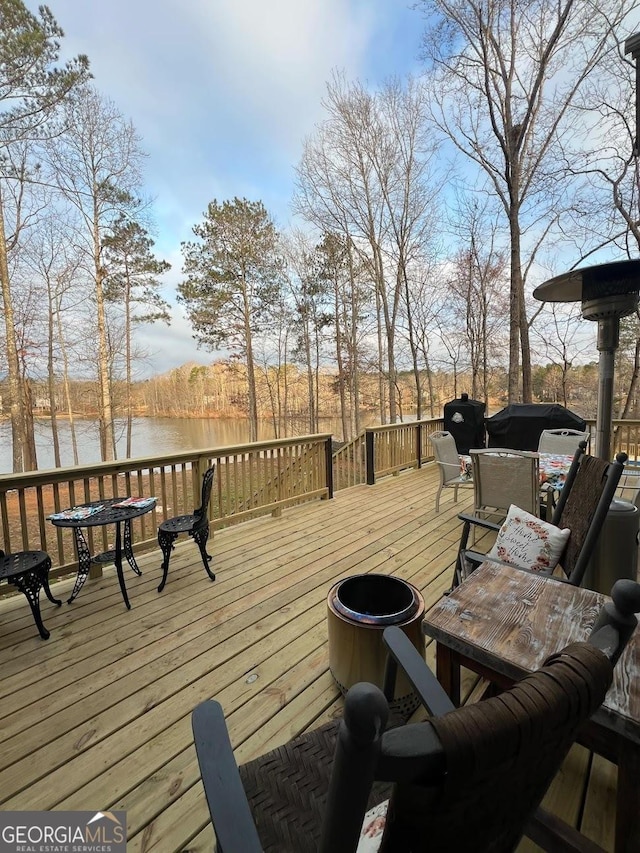 wooden deck with a water view