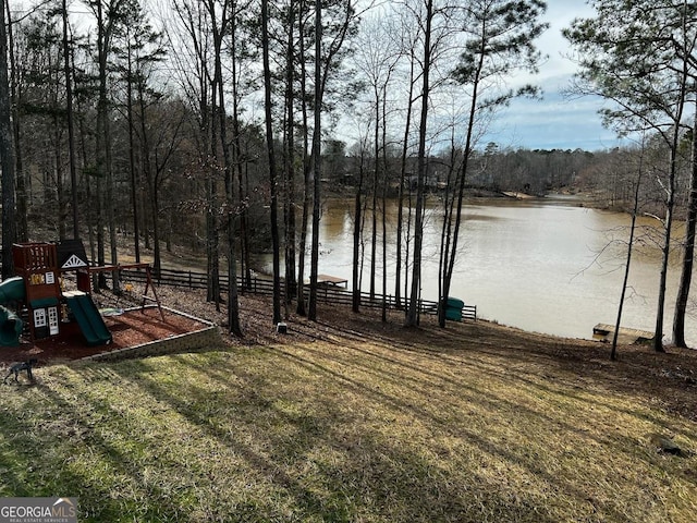 view of yard featuring a playground and a water view