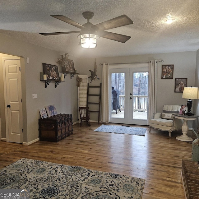 interior space with ceiling fan, hardwood / wood-style floors, a textured ceiling, and french doors