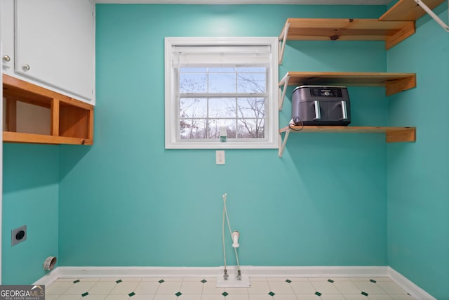 washroom featuring hookup for an electric dryer and baseboards