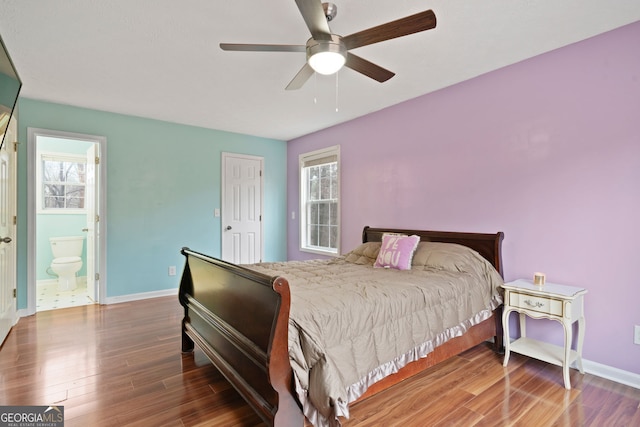 bedroom with wood finished floors, baseboards, ensuite bath, and ceiling fan