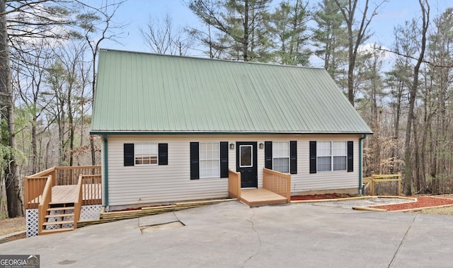view of front of home with metal roof and a wooden deck