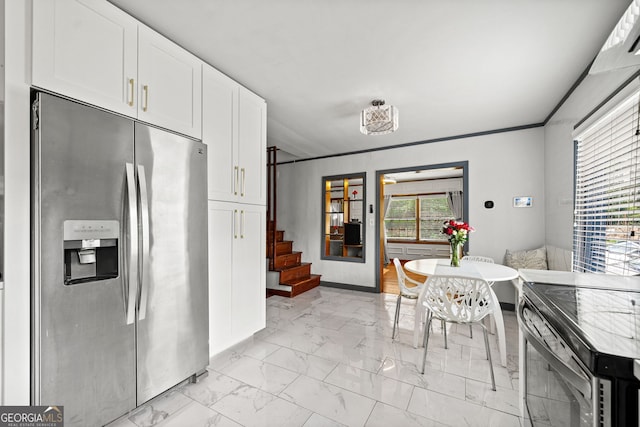 kitchen with white cabinetry, crown molding, and stainless steel appliances