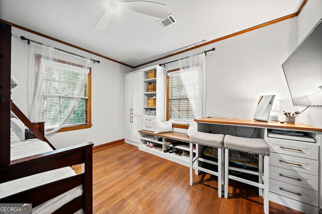 bedroom with crown molding, ceiling fan, and hardwood / wood-style flooring